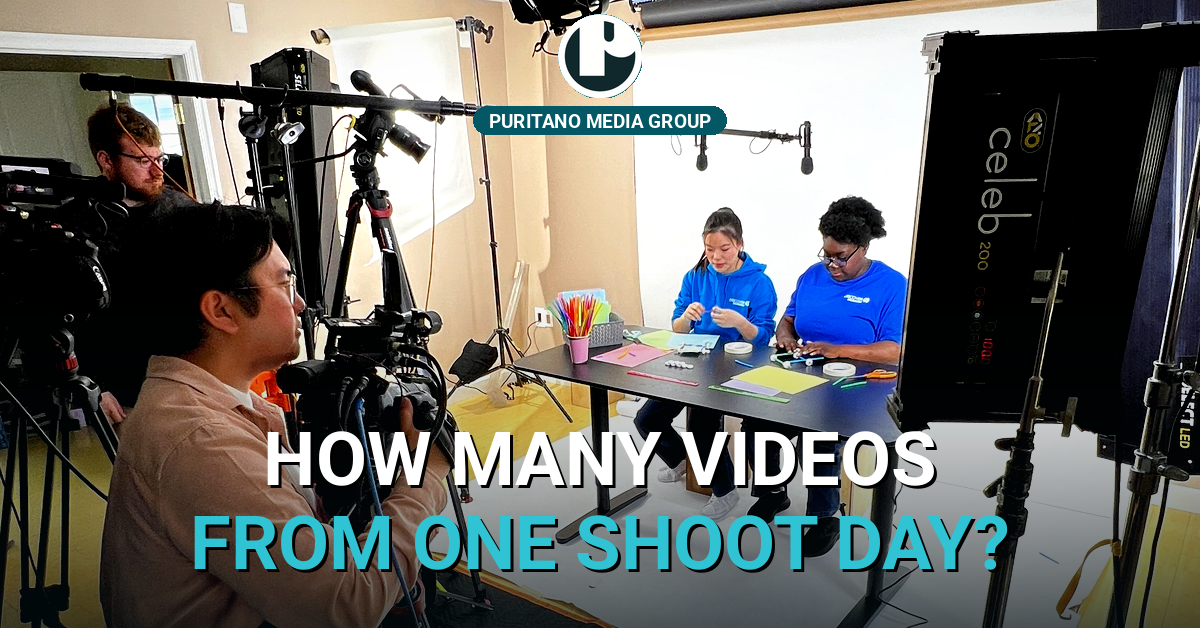A PMG live production set with two presenters at a desk and cameras rolling
